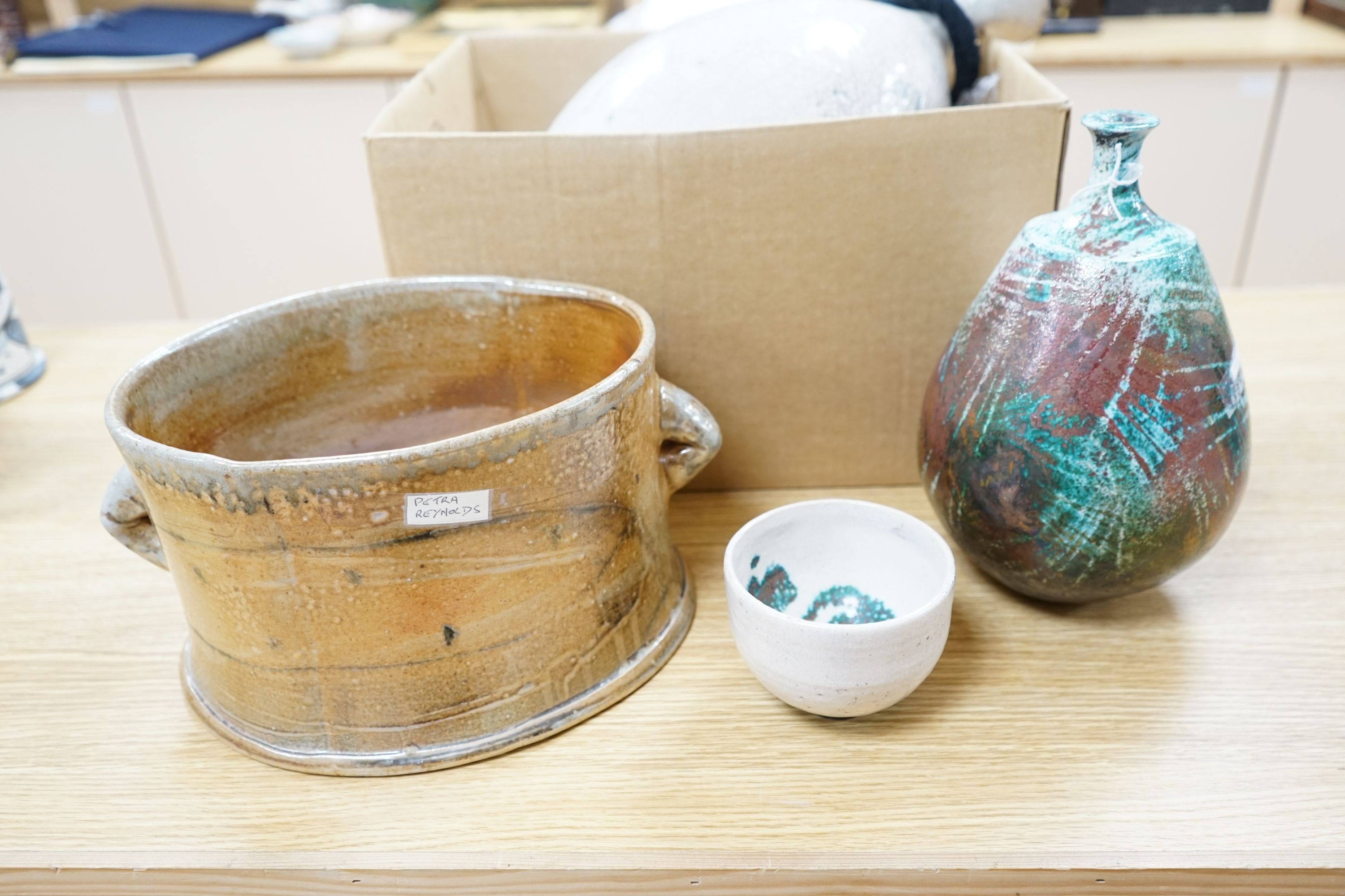 Studio pottery- an Allison Weightman raku fired large albastron form vase, ovoid vase and cup and a Petra Reynolds oval stoneware pot (4) Tallest 44cm